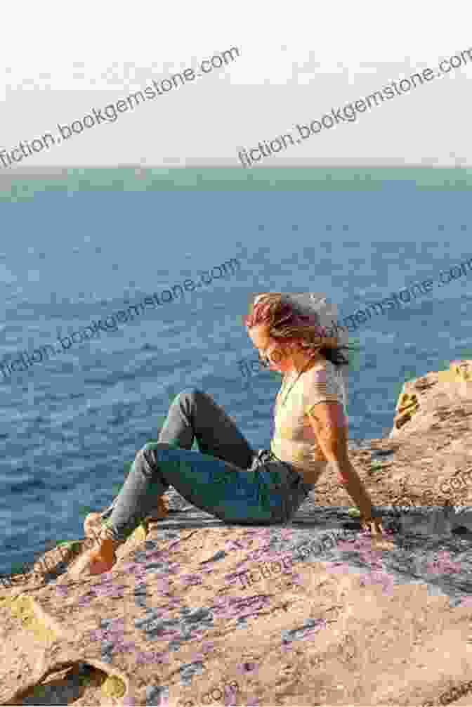 A Person Sitting On A Clifftop, Looking Out At The Vast Ocean, Symbolizing The Journey Of Self Discovery A Journey Of Self Discovery: Traveling Around South America To Find Out Meaningful Things